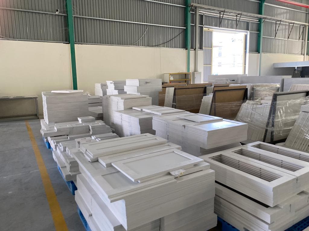 Stacks of finished Shaker White cabinet doors