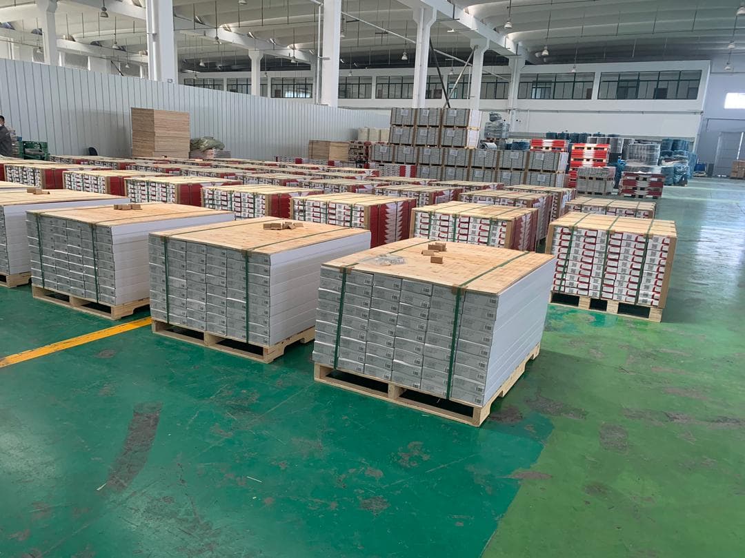 Warehouse floor lined with strapped pallets of boxed flooring
