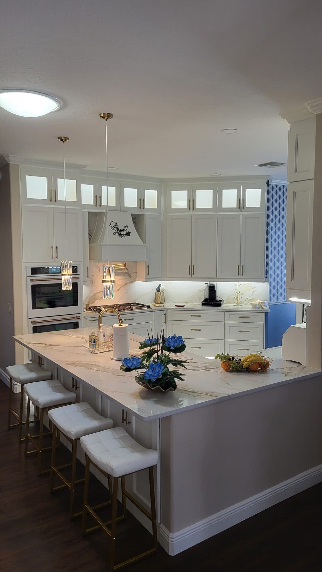 White Kitchen with Glass Uppers and Island Seating