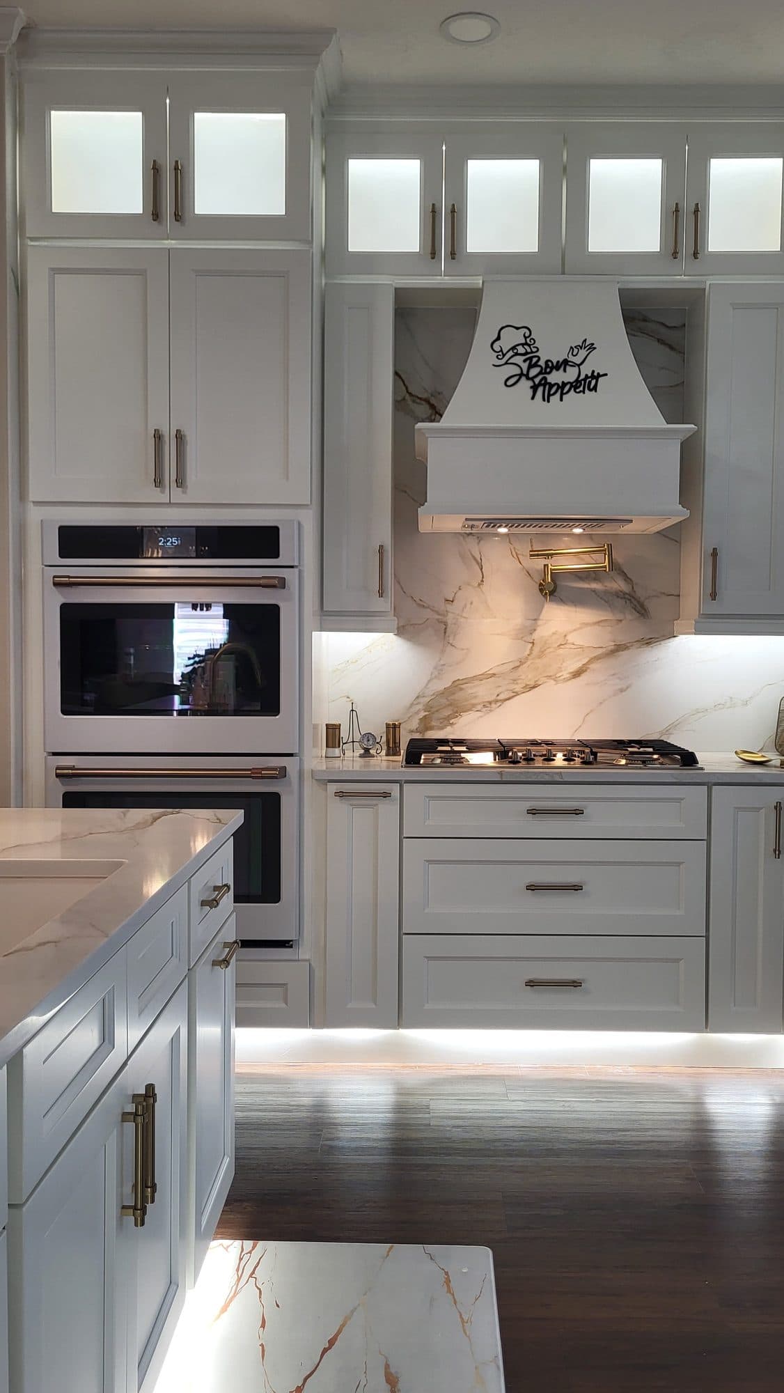 White Kitchen with Wall Ovens and Range Hood
