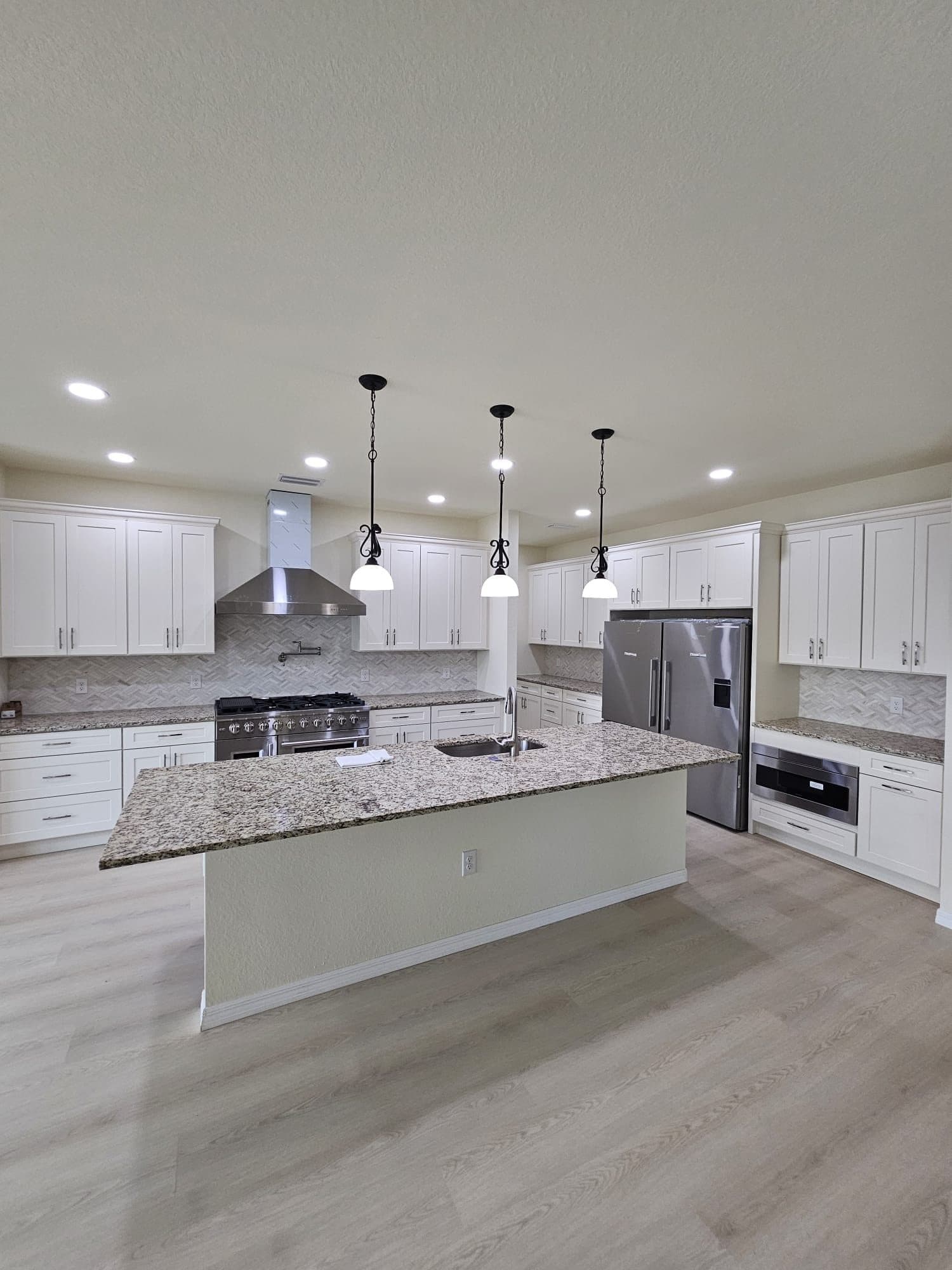 White Kitchen with Island and Pendants