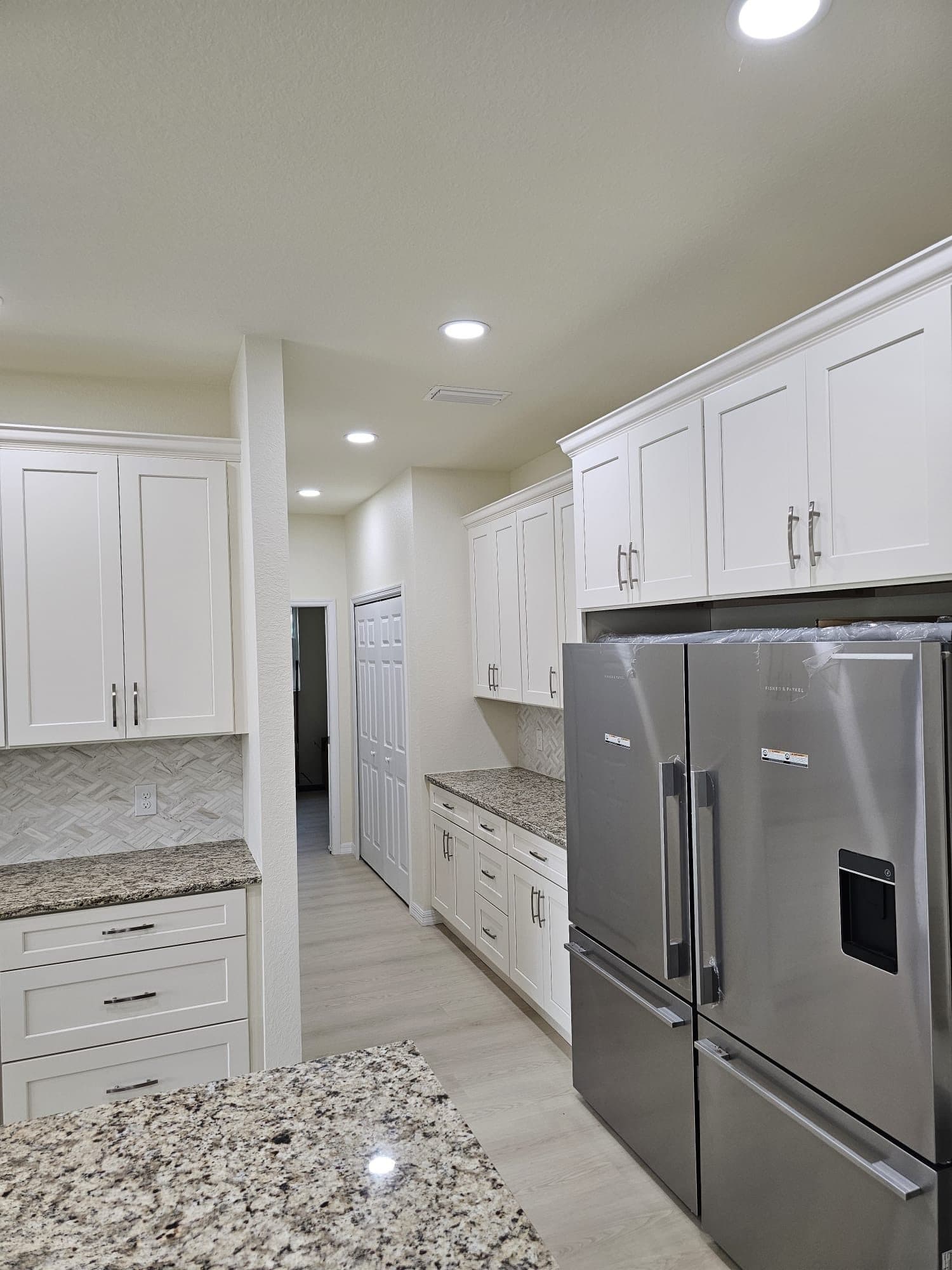 White Kitchen with Stainless Appliances