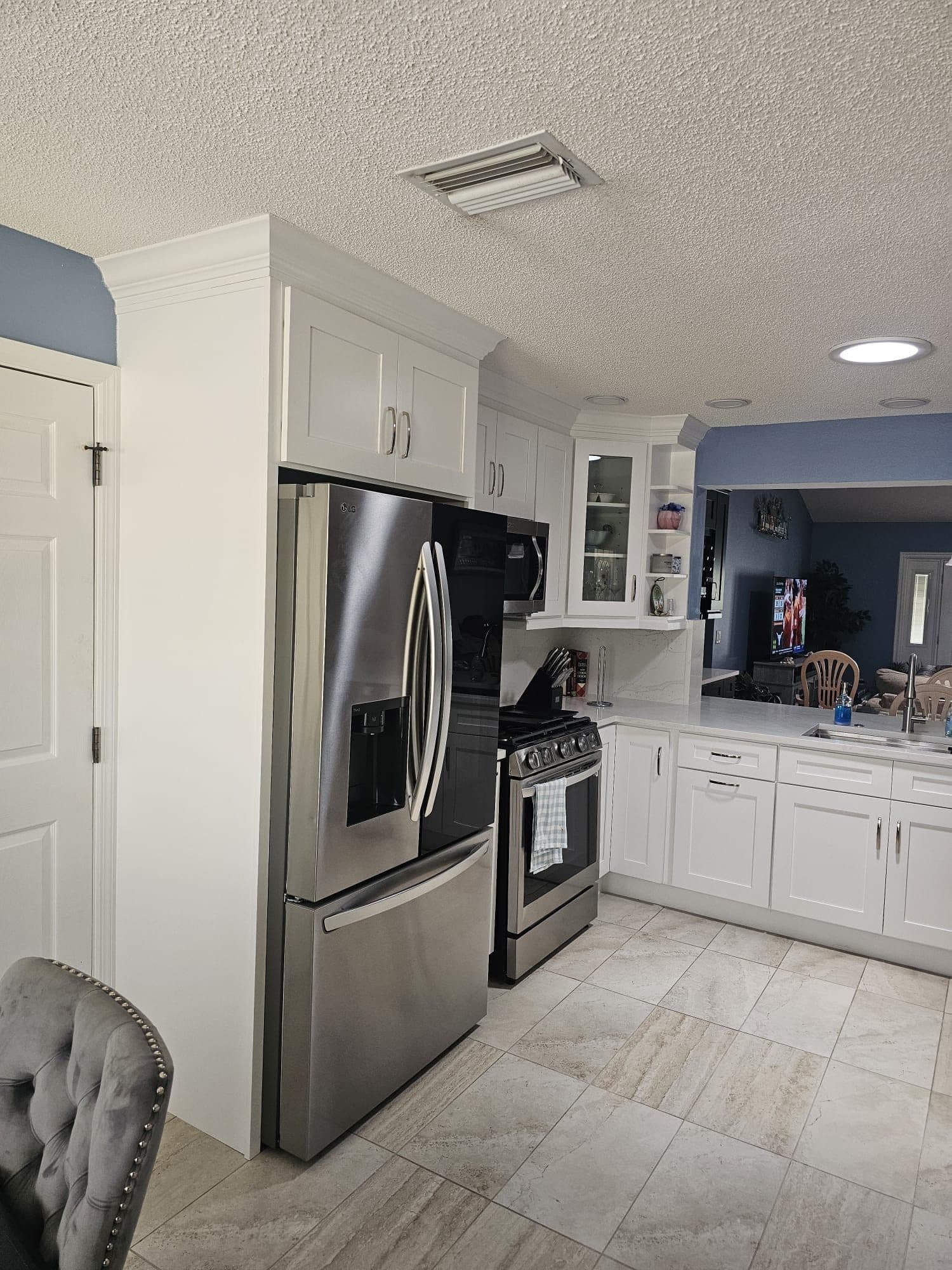 White Kitchen with Stainless Refrigerator