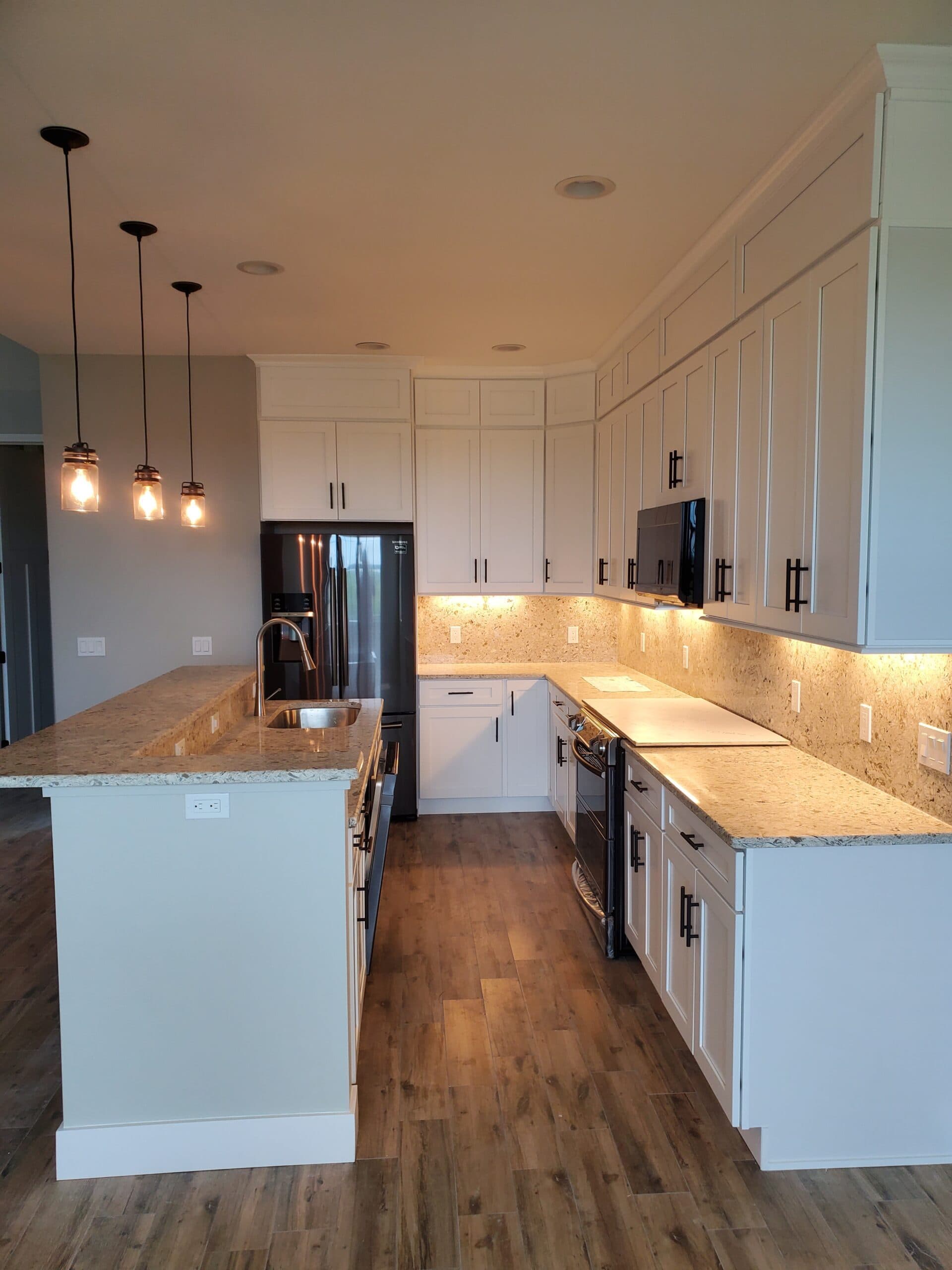 White shaker kitchen cabinets with quartz countertops from the Glide-Lock product line