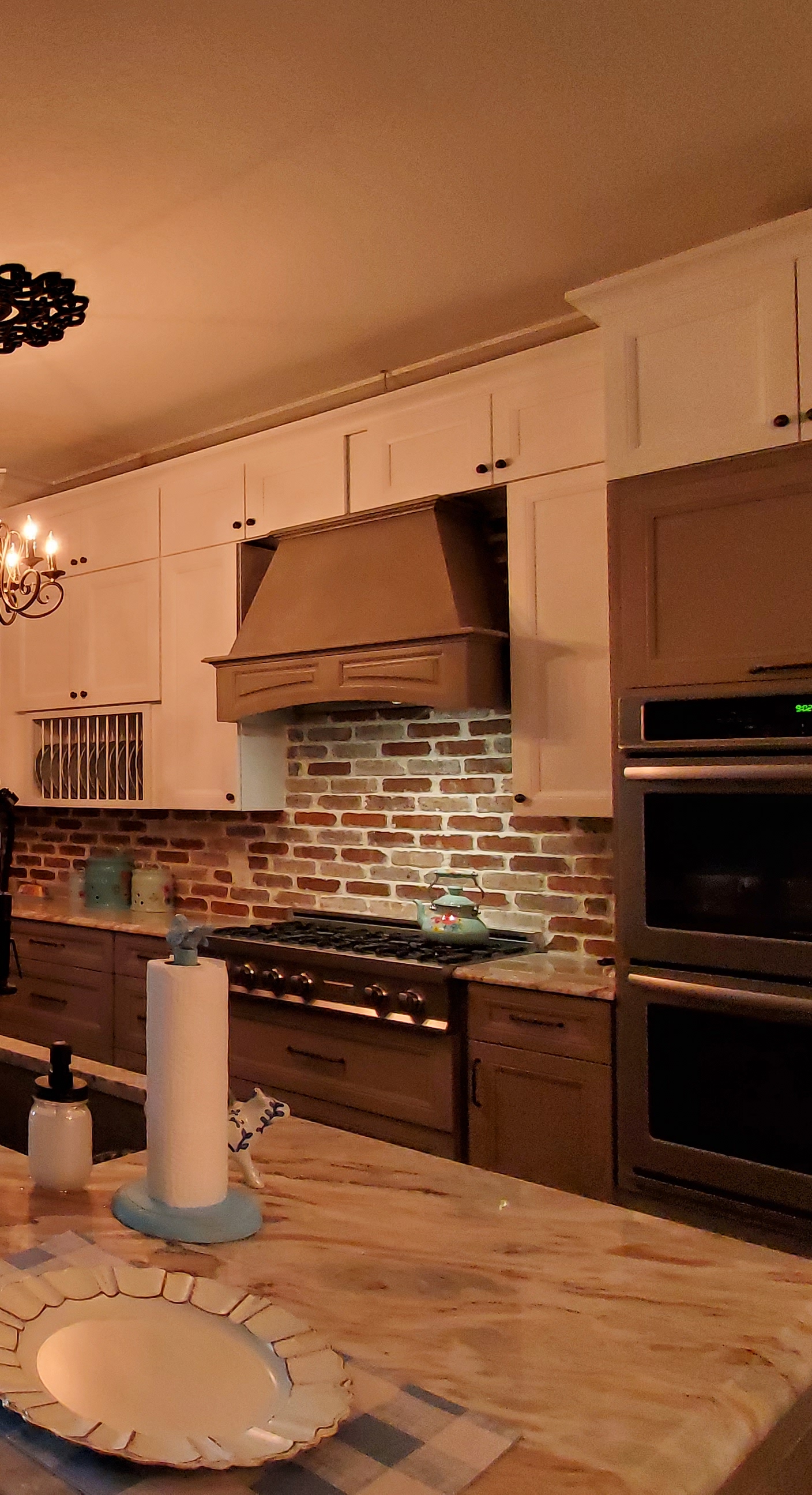 Brown brick kitchen with wood hood