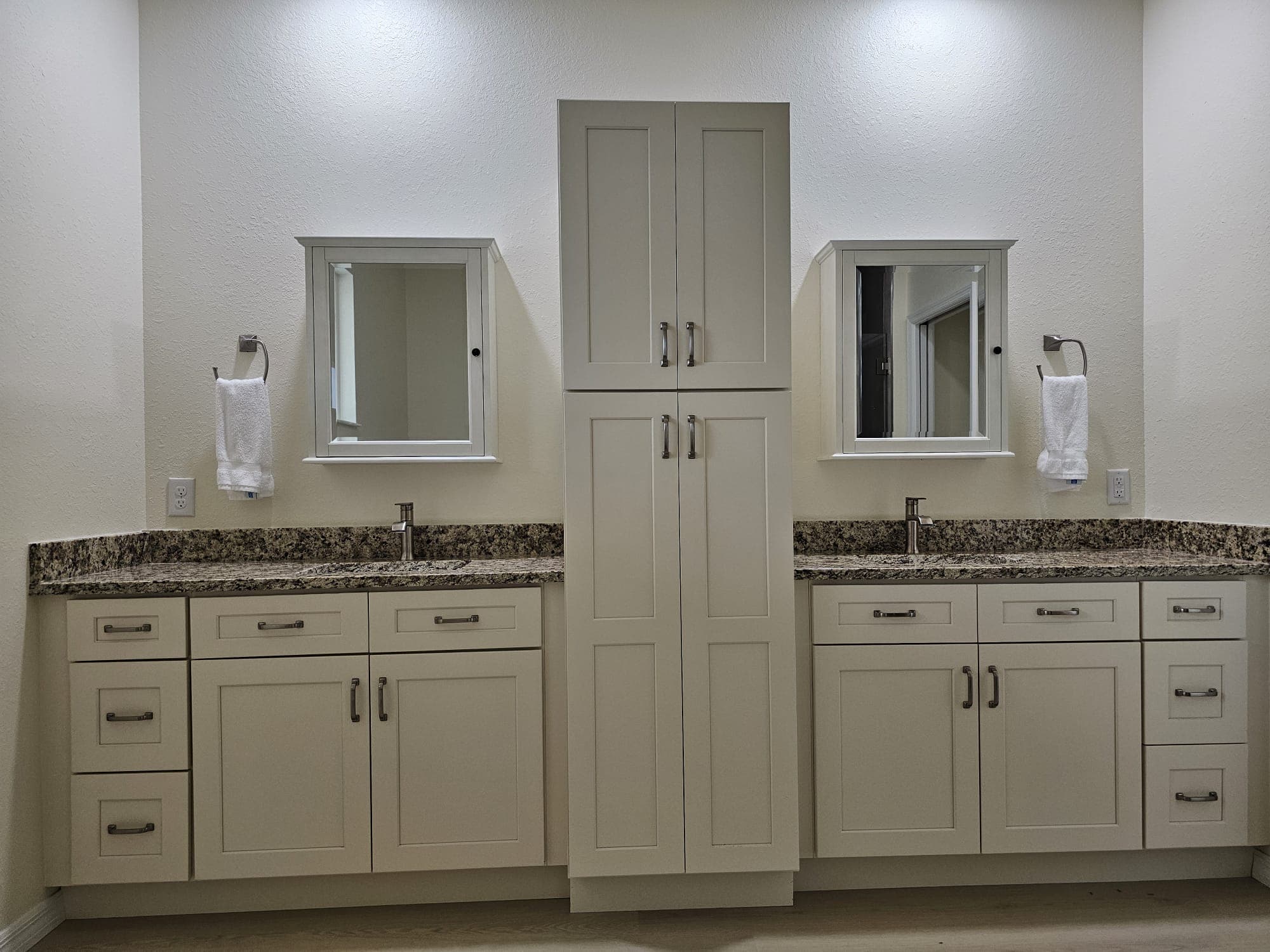 Cream shaker vanity with center tower cabinet and granite top
